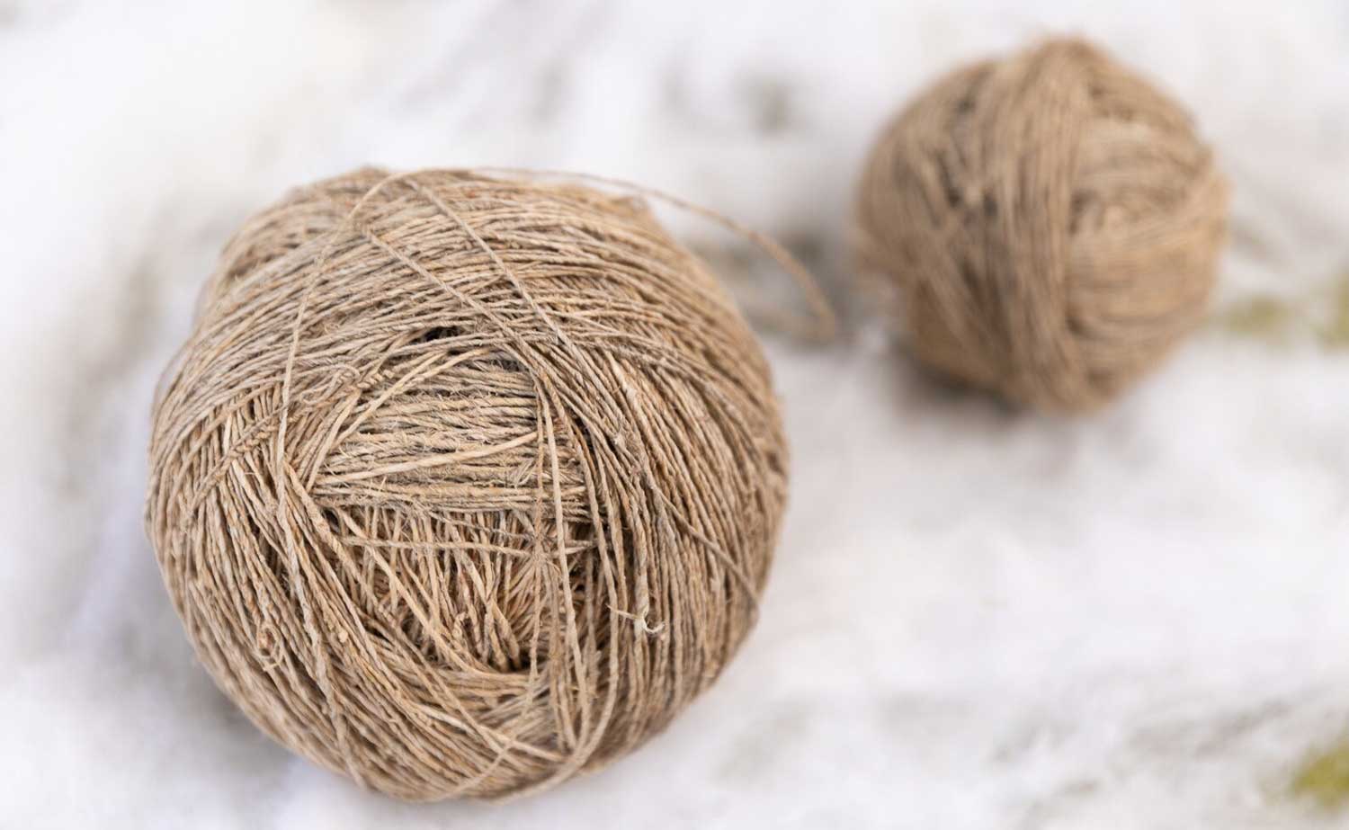 Photograph of brown yarn roughly spun into a ball