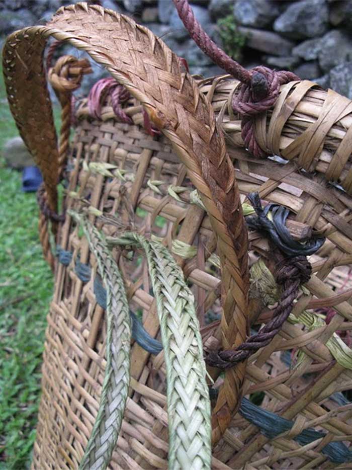 Photograph of woven bamboo strap on traditional rattan like baskets